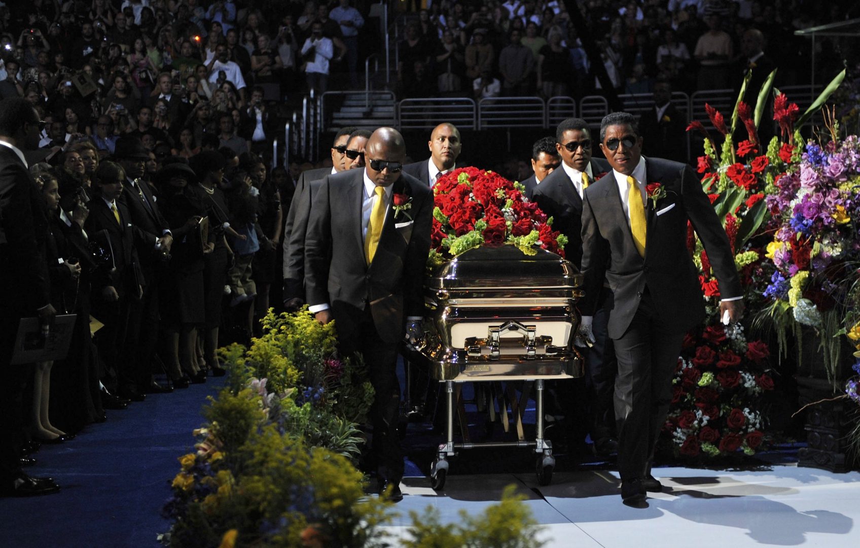 Michael Jackson's casket is brought out during public memorial service held at Staples Center in Los Angeles July 7, 2009. A Gospel choir singing "We're going to see the king" launched an emotional public memorial for Michael Jackson on Tuesday as the music world and thousands of fans bade farewell to the singer known as the "King of Pop."      REUTERS/Harrison Funk/Handout  (UNITED STATES)    NO SALES NO ARCHIVE (ENTERTAINMENT OBITUARY IMAGES OF THE DAY)